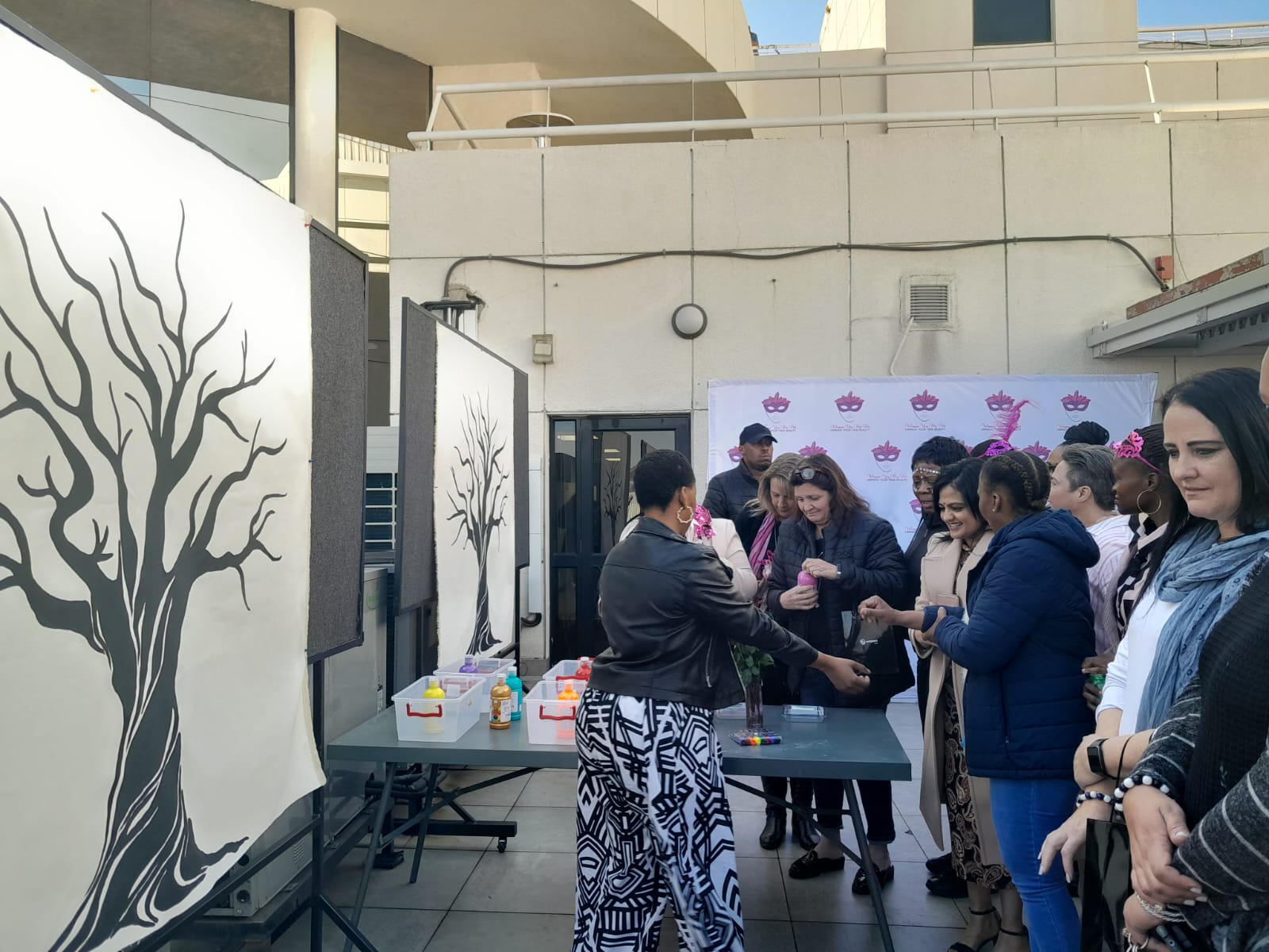 Picture of guests placing their hand prints on a Tree Canvas.